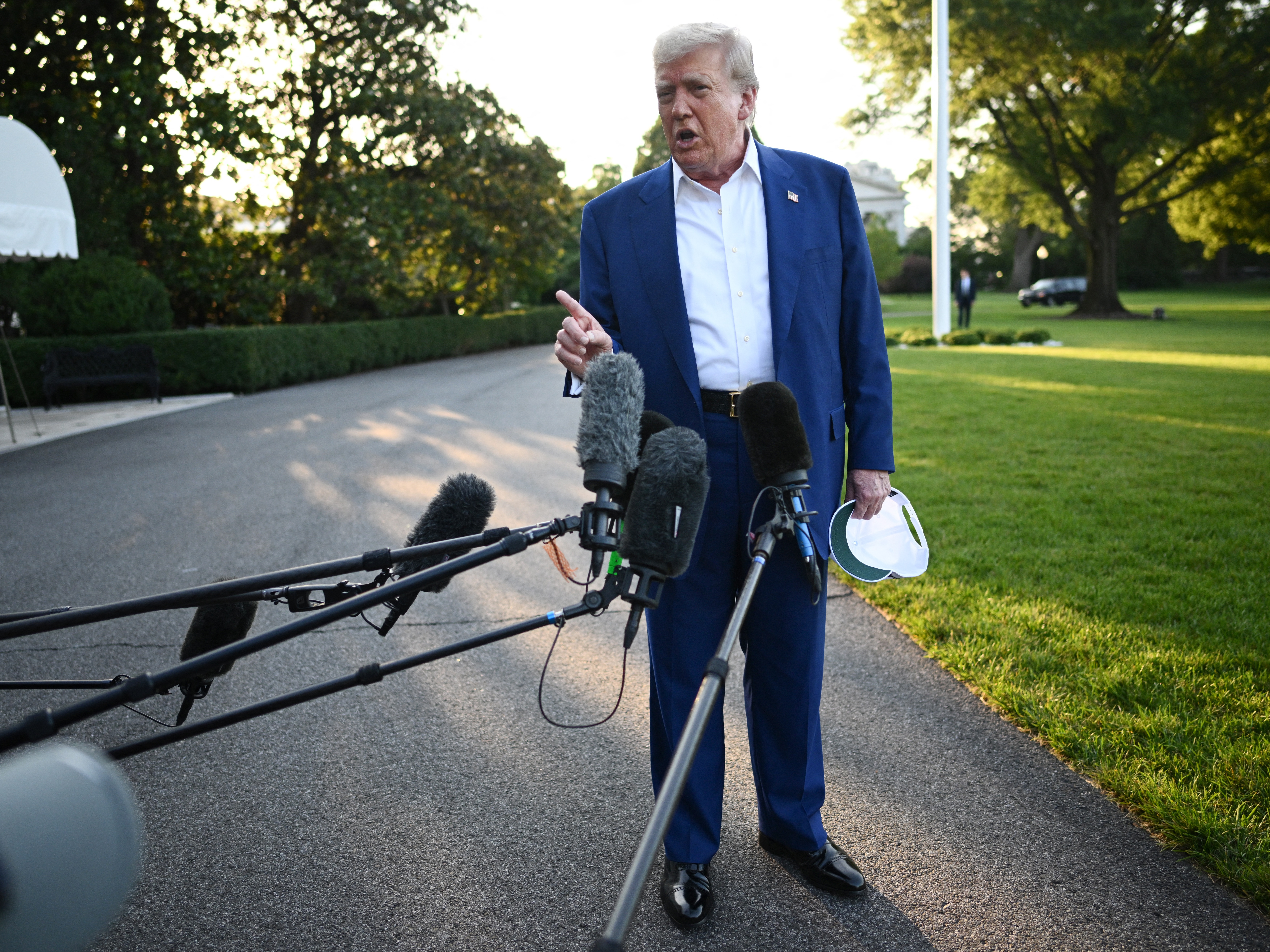 caption: President Trump speaks to the press before boarding Marine One from the South Lawn of the White House on June 24 to attend the NATO leaders' summit in The Hague.
