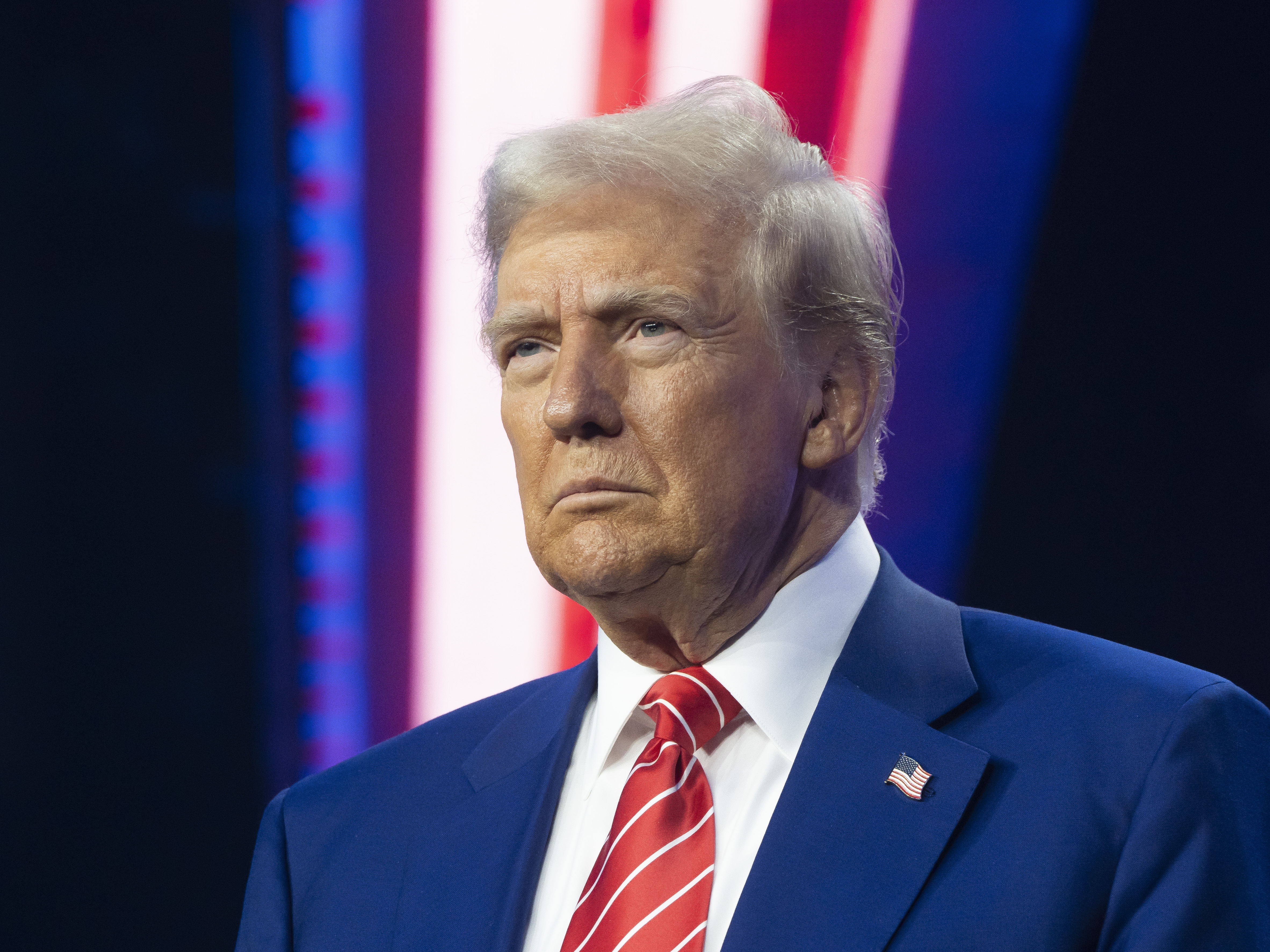 caption: President-elect Donald Trump looks on during Turning Point USA's AmericaFest at the Phoenix Convention Center in December 2024 in Phoenix, Ariz.