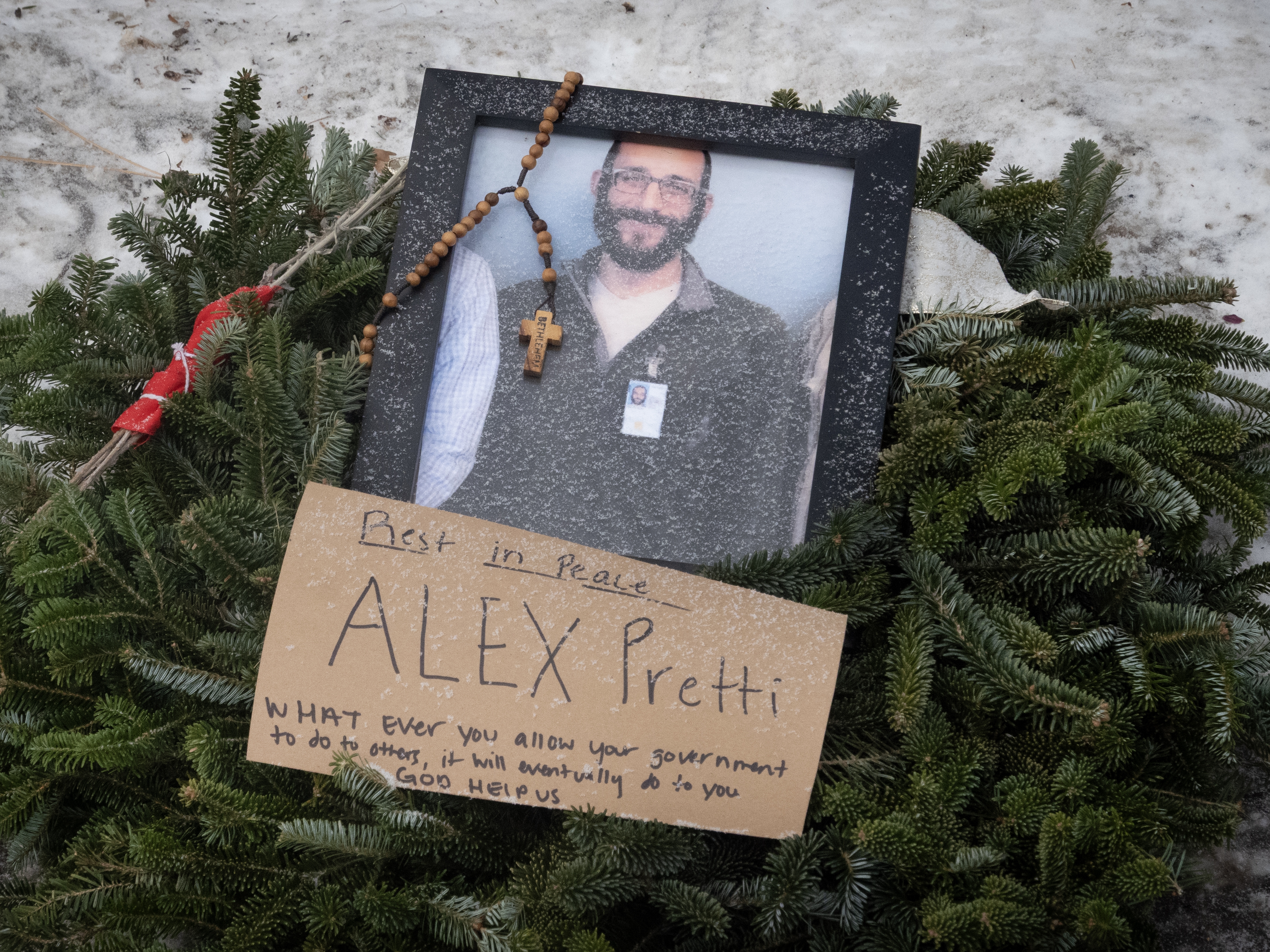 caption: A picture sits at a memorial to Alex Pretti on Jan. 25, 2026 in Minneapolis, Minn.