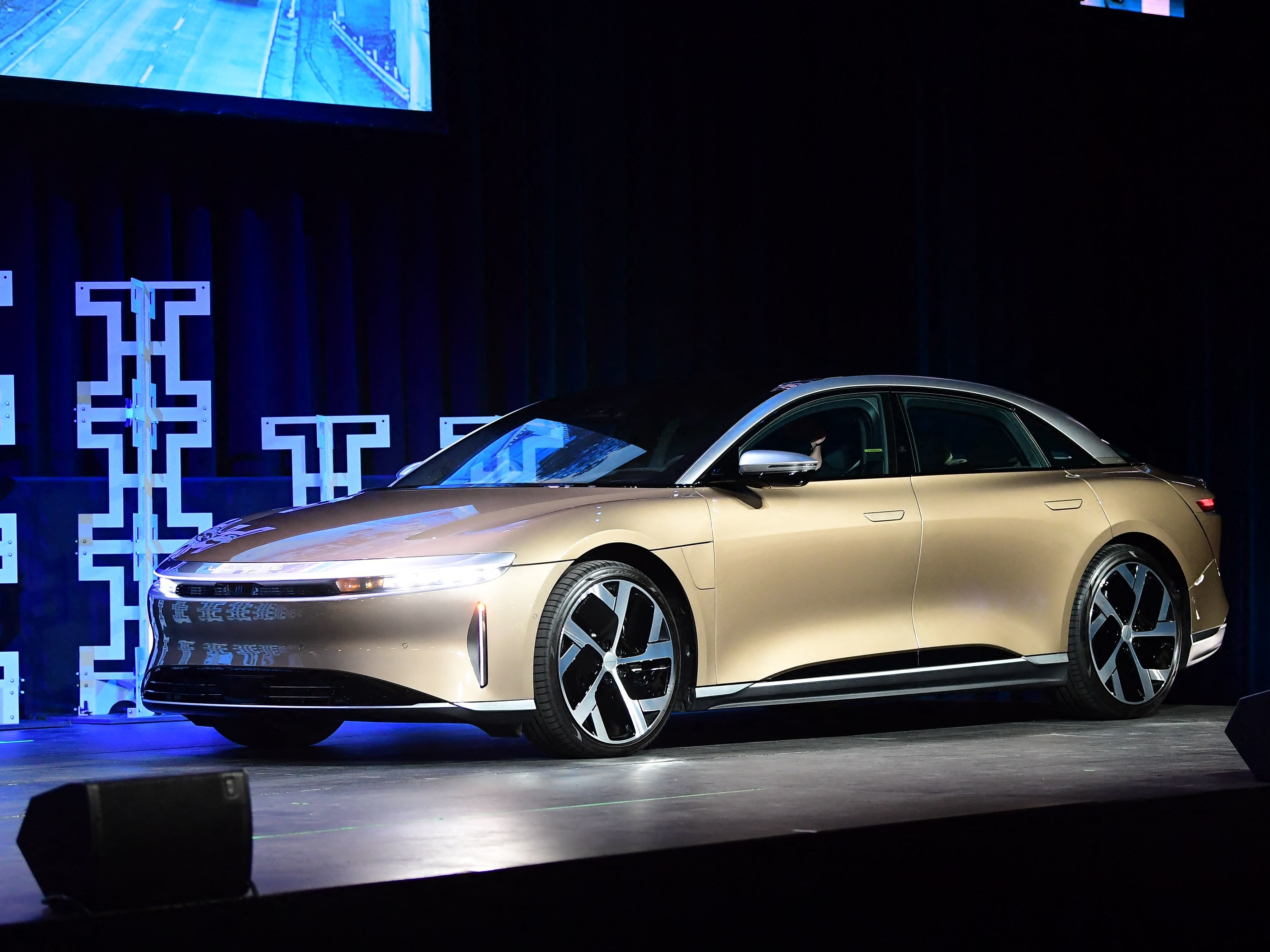 caption: The Lucid Air takes the stage at the 2021 LA Autoshow on November 17, 2021. The luxury electric sedan won the 2022 Motortrend Car of the Year award this month.