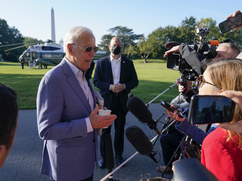 caption: President Joe Biden speaks with members of the press before boarding Marine One on the South Lawn of the White House, Saturday, Oct. 2, 2021, in Washington. Biden spent the weekend at his home in Delaware.