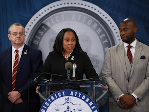 caption: Fulton County District Attorney Fani Willis speaks in Atlanta on Aug. 14, 2023, after former President Donald Trump and his allies were indicted on state charges. At right is special prosecutor Nathan Wade. A personal relationship between Willis and Wade is at the center of misconduct claims against the DA's office.