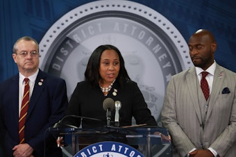 caption: Fulton County District Attorney Fani Willis speaks in Atlanta on Aug. 14, 2023, after former President Donald Trump and his allies were indicted on state charges. At right is special prosecutor Nathan Wade. A personal relationship between Willis and Wade is at the center of misconduct claims against the DA's office.