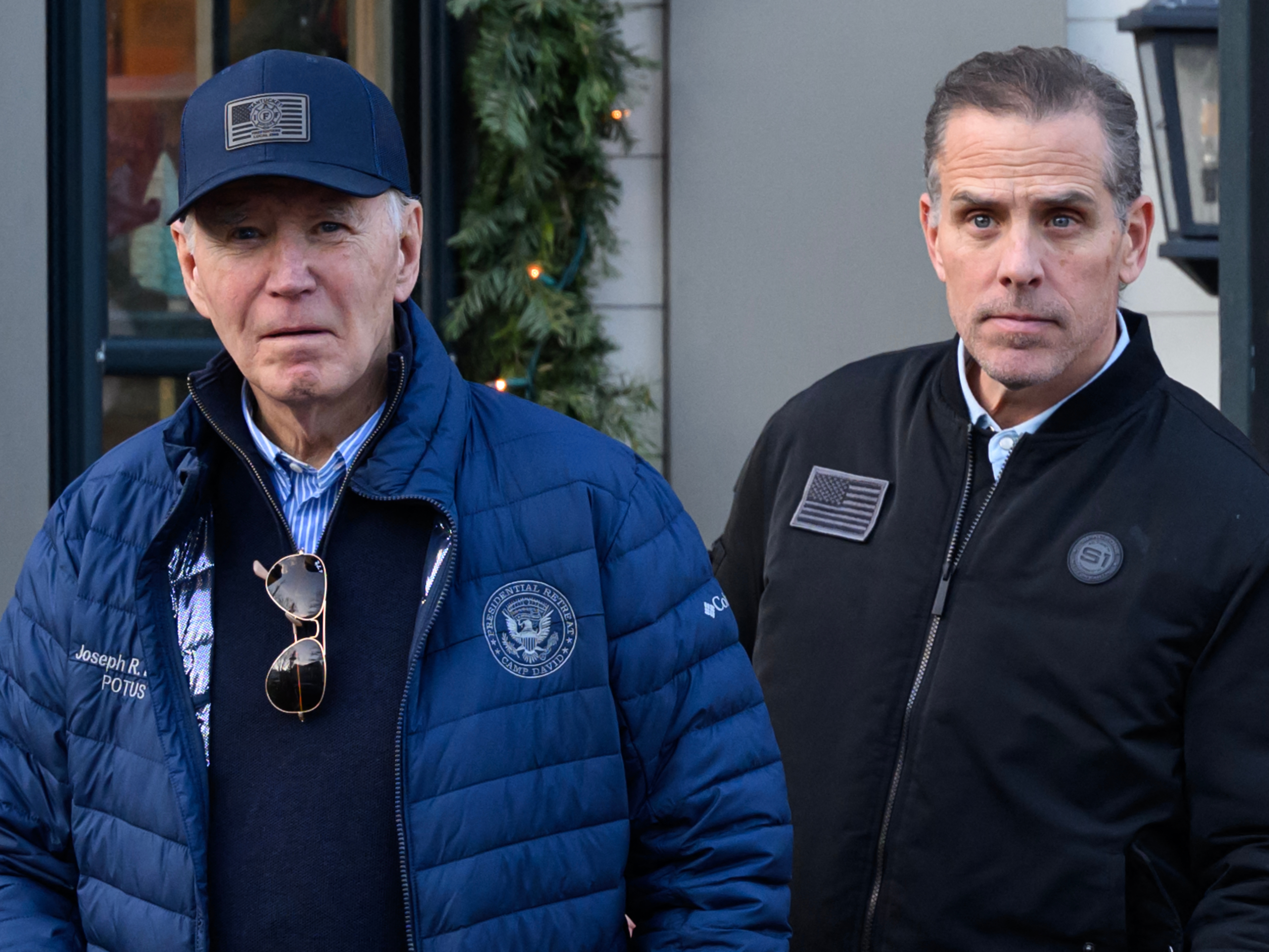 caption: A Nov. 29, 2024, photo shows President Biden and son Hunter Biden stepping out of a bookstore while shopping in Nantucket, Mass.