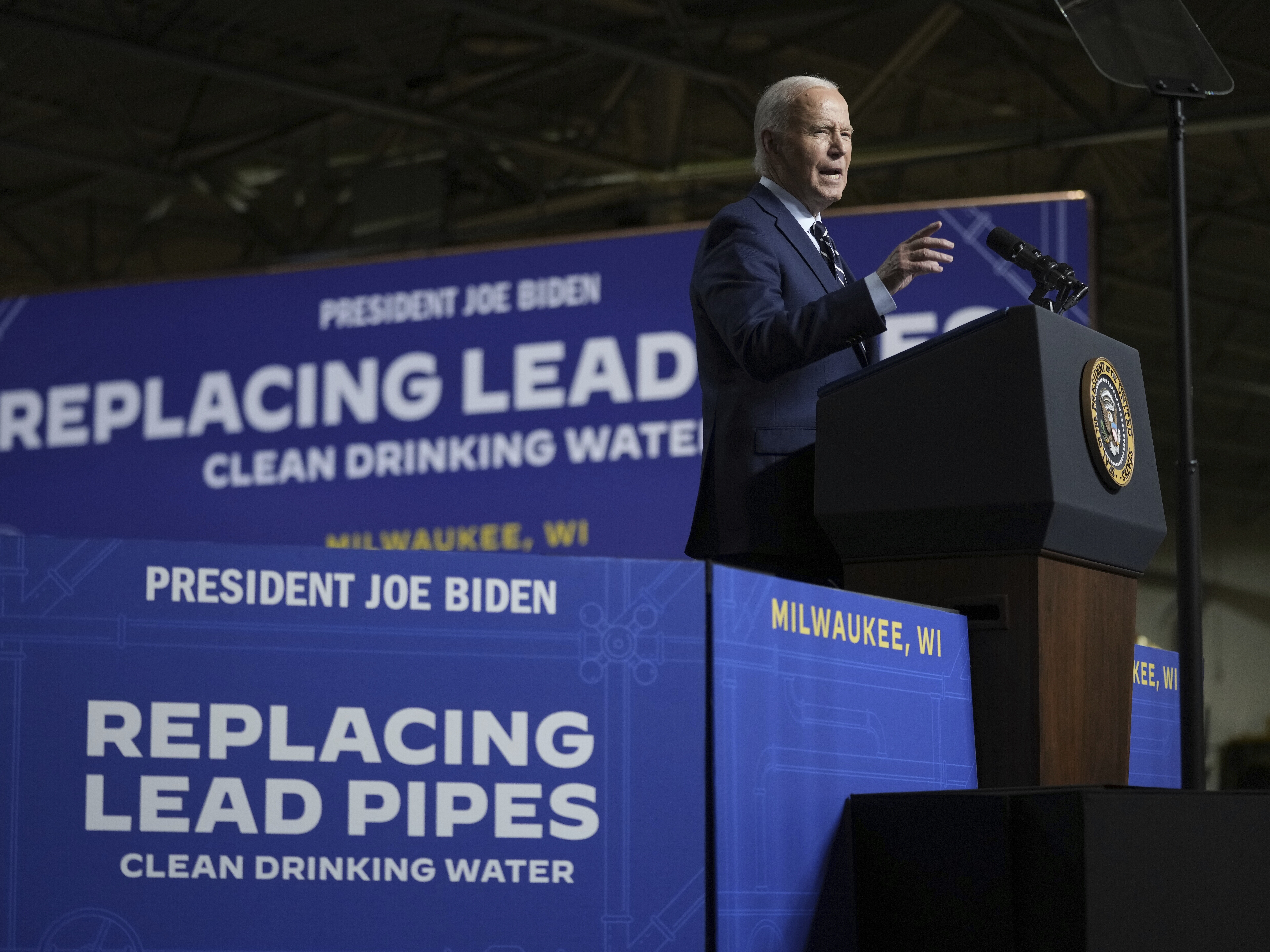 caption: President Biden speaks at an event at the Milwaukee Department of Public Works in Milwaukee, Tuesday, Oct. 8, 2024, to discuss his administration's progress in replacing lead pipes in Wisconsin and across the country.