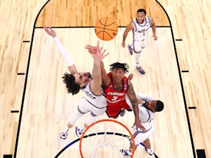 caption: Giancarlo Rosado of the Florida Atlantic Owls shoots over Ismael Massoud of the Kansas State Wildcats during the Elite Eight round of the 2023 NCAA Men's Basketball Tournament held at Madison Square Garden on March 25.