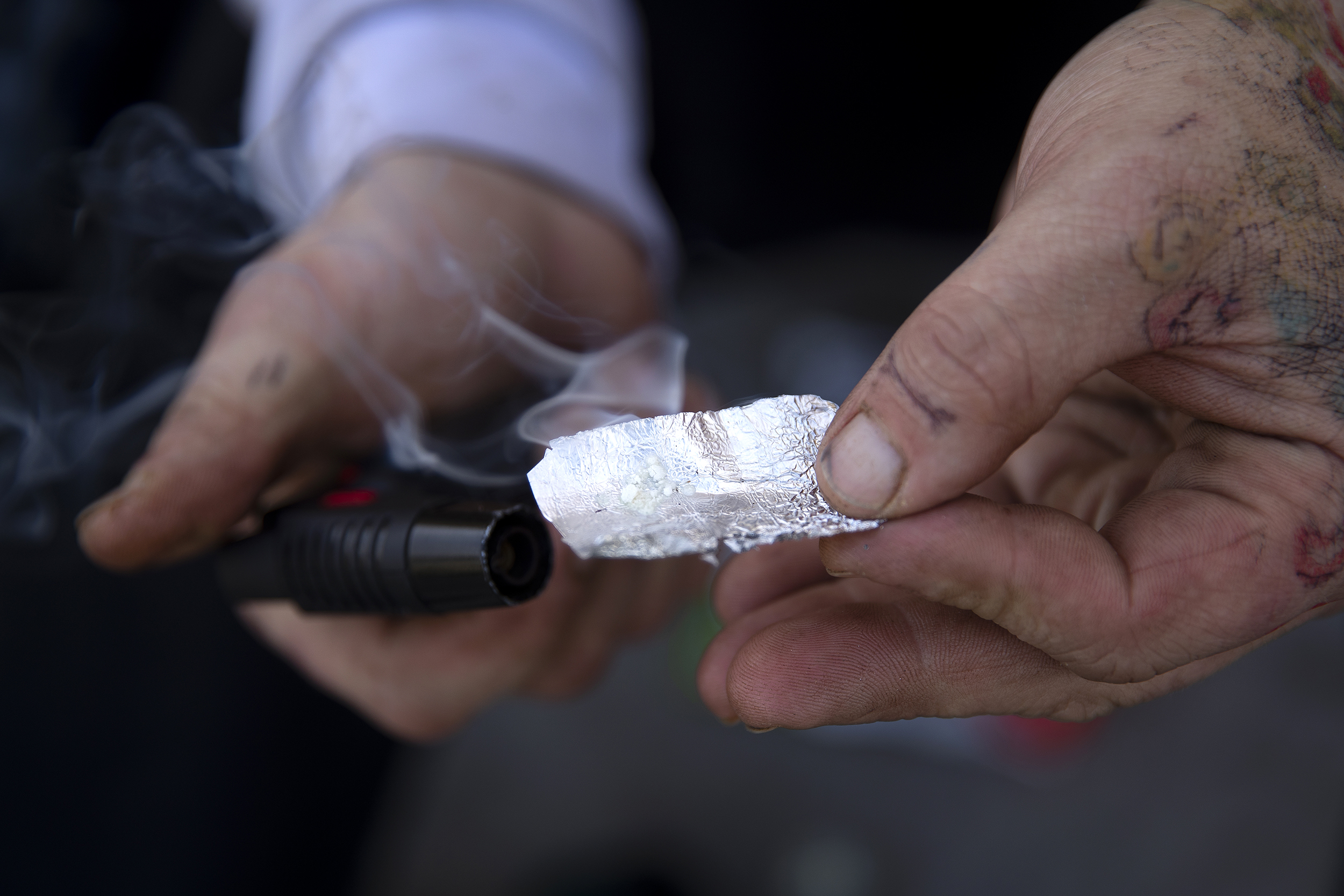 caption: Fentanyl is heated before being smoked at Hoa Mai Park on Tuesday, March 25, 2025, in Seattle’s Little Saigon neighborhood.