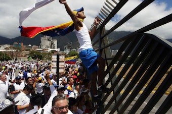 caption: Supporters of Venezuelan opposition leader Juan Guaidó take part in a march in Caracas in February 2019. Amid Venezuela's isolation and catastrophic economic conditions, Guaidó emerged as a key challenger to Nicolás Maduro's rule, but has had difficulty sustaining his initial mass momentum in support.