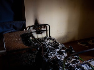 caption: A burned cot in a police station in Kherson on Wednesday. Kherson residents say Russians used the police station to detain and torture violators of curfew and people suspected of collaborating with Ukrainian authorities.