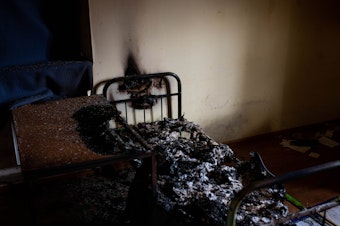 caption: A burned cot in a police station in Kherson on Wednesday. Kherson residents say Russians used the police station to detain and torture violators of curfew and people suspected of collaborating with Ukrainian authorities.