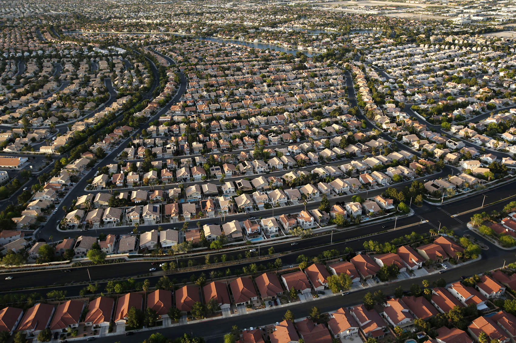 caption: Houses line streets near the edge of the Las Vegas valley in Las Vegas. (John Locher/AP)