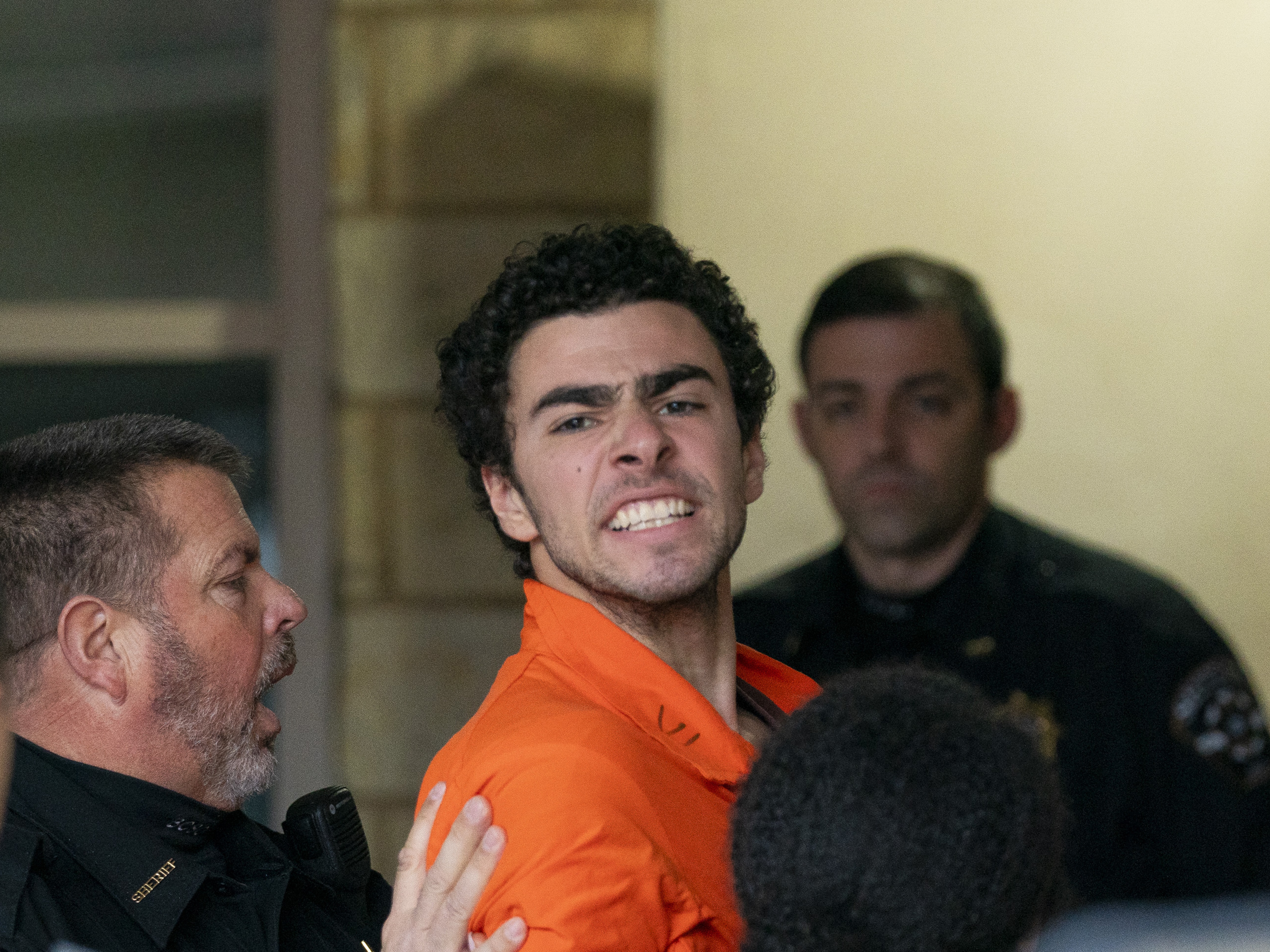 caption: Suspect Luigi Mangione is taken into the Blair County Courthouse on Dec. 10 in Hollidaysburg, Pa.