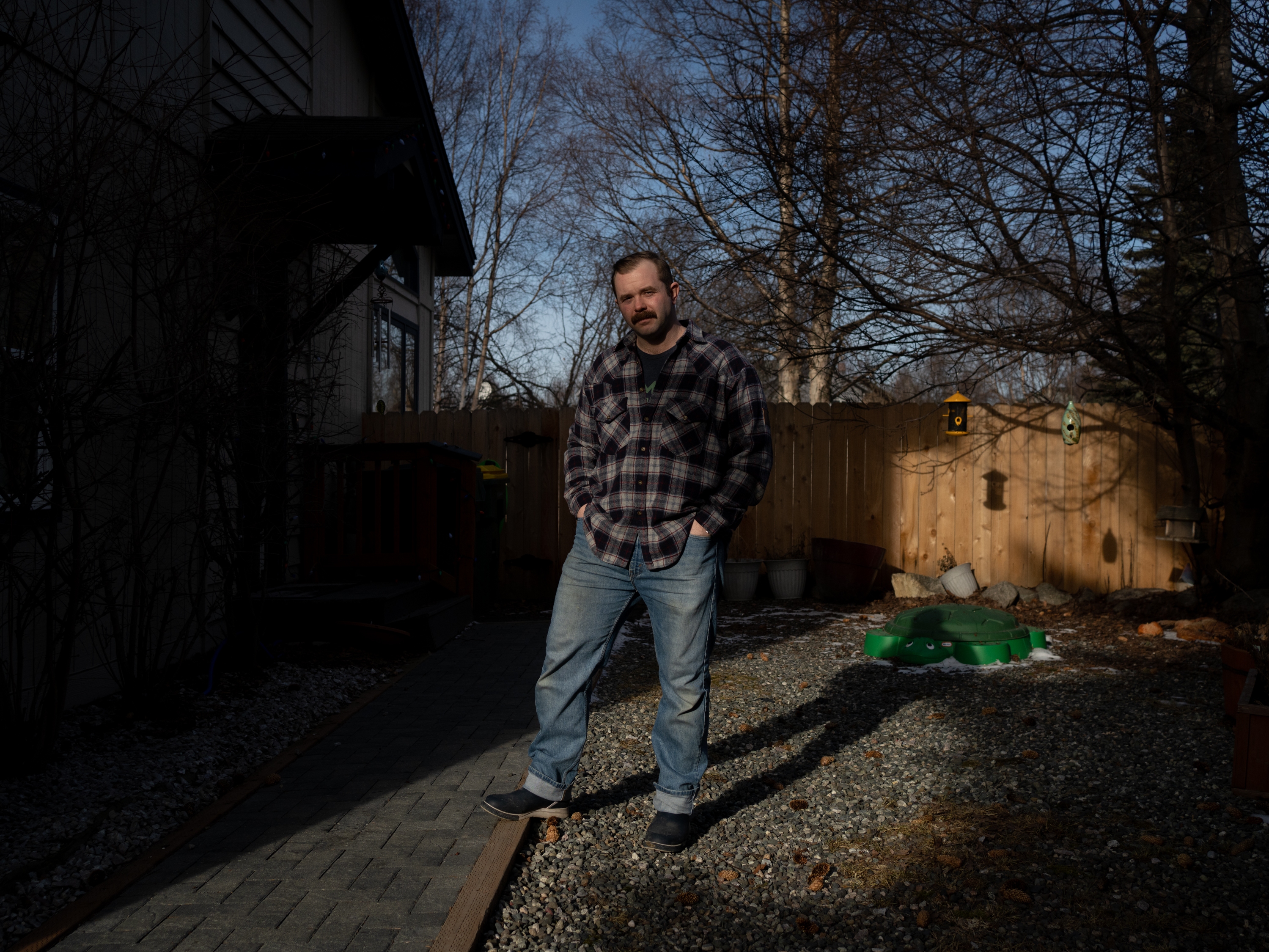 caption: Mike Macans stands for a portrait outside of his home in Anchorage, Alaska, on Feb. 23, 2025. Macans served in the U.S. Army for five years and was most recently working as a disaster recovery coordinator for the Small Business Administration. He was officially terminated from his job on Feb. 11, 2025.