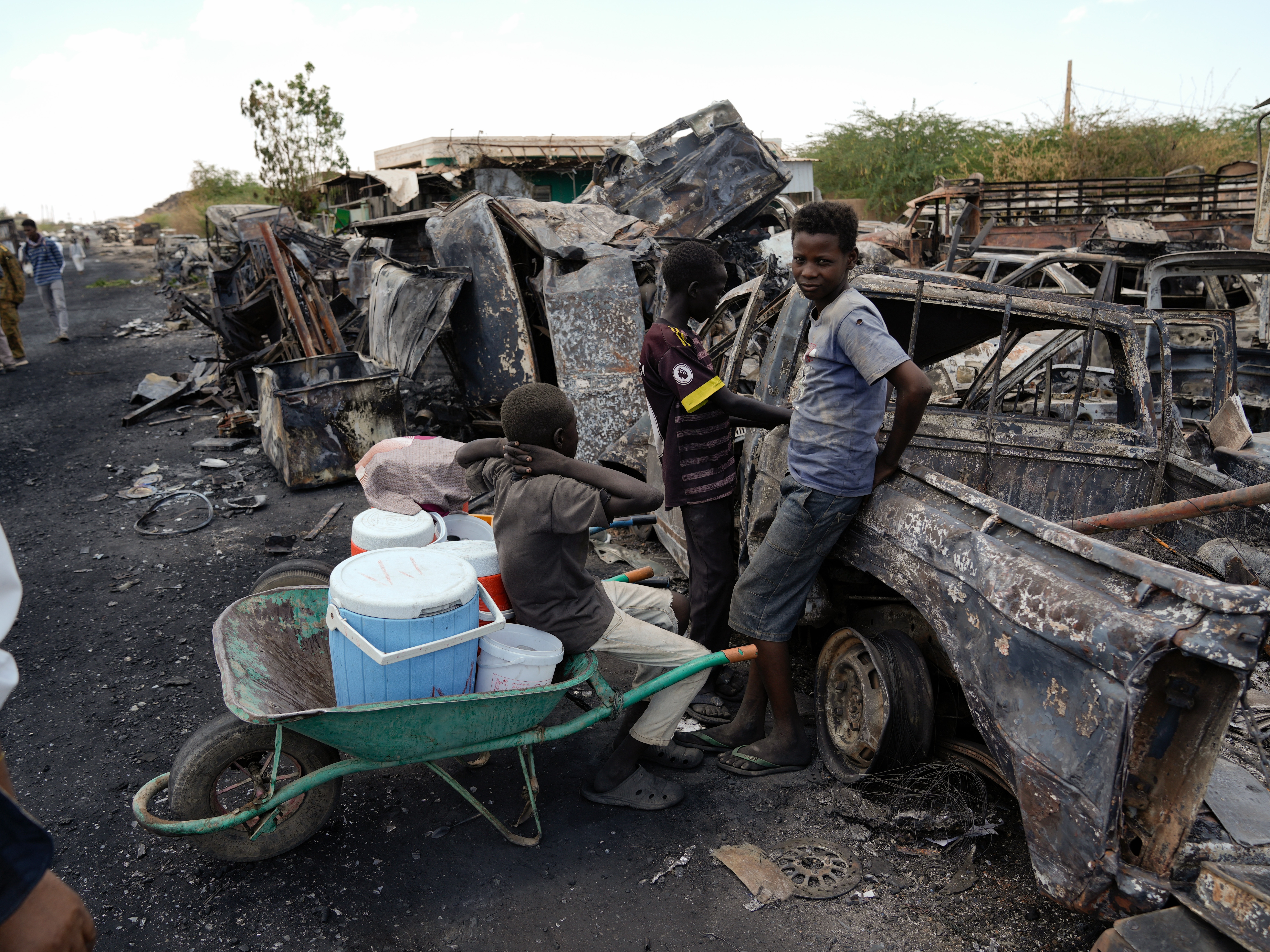 caption: Children selling a drink made from hibiscus flowers in Jebel Aulia, a neighborhood on the outskirts of Khartoum where the last battles over control of the capital city took place. The Sudanese government took the city back from rebel forces in March.