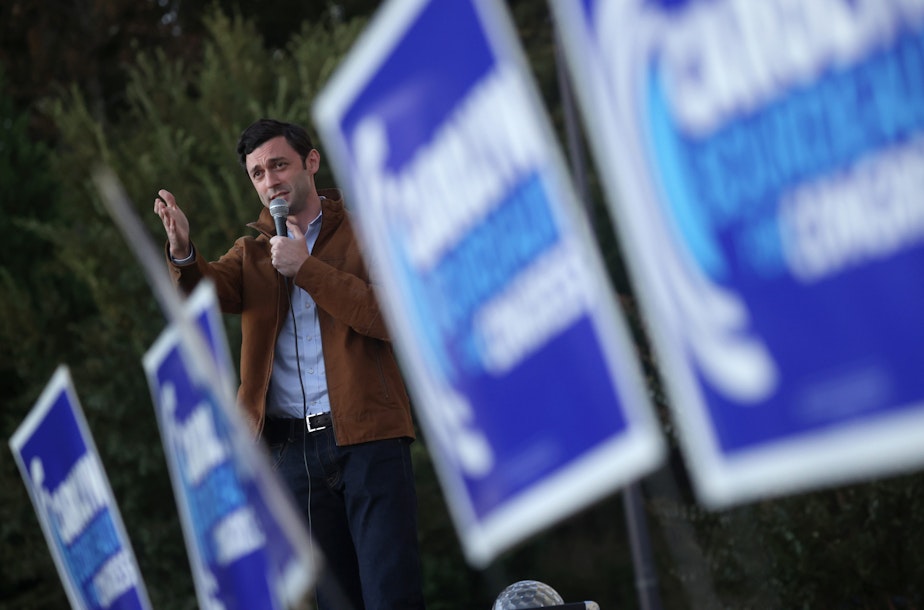 caption: Democratic U.S. Senate candidate Jon Ossoff speaks during a “Don’t Boo, Early Vote” event outside of Pleasant Hill Baptist Church on November 30, 2020 in Lawrenceville, Georgia. (Justin Sullivan/Getty Images)