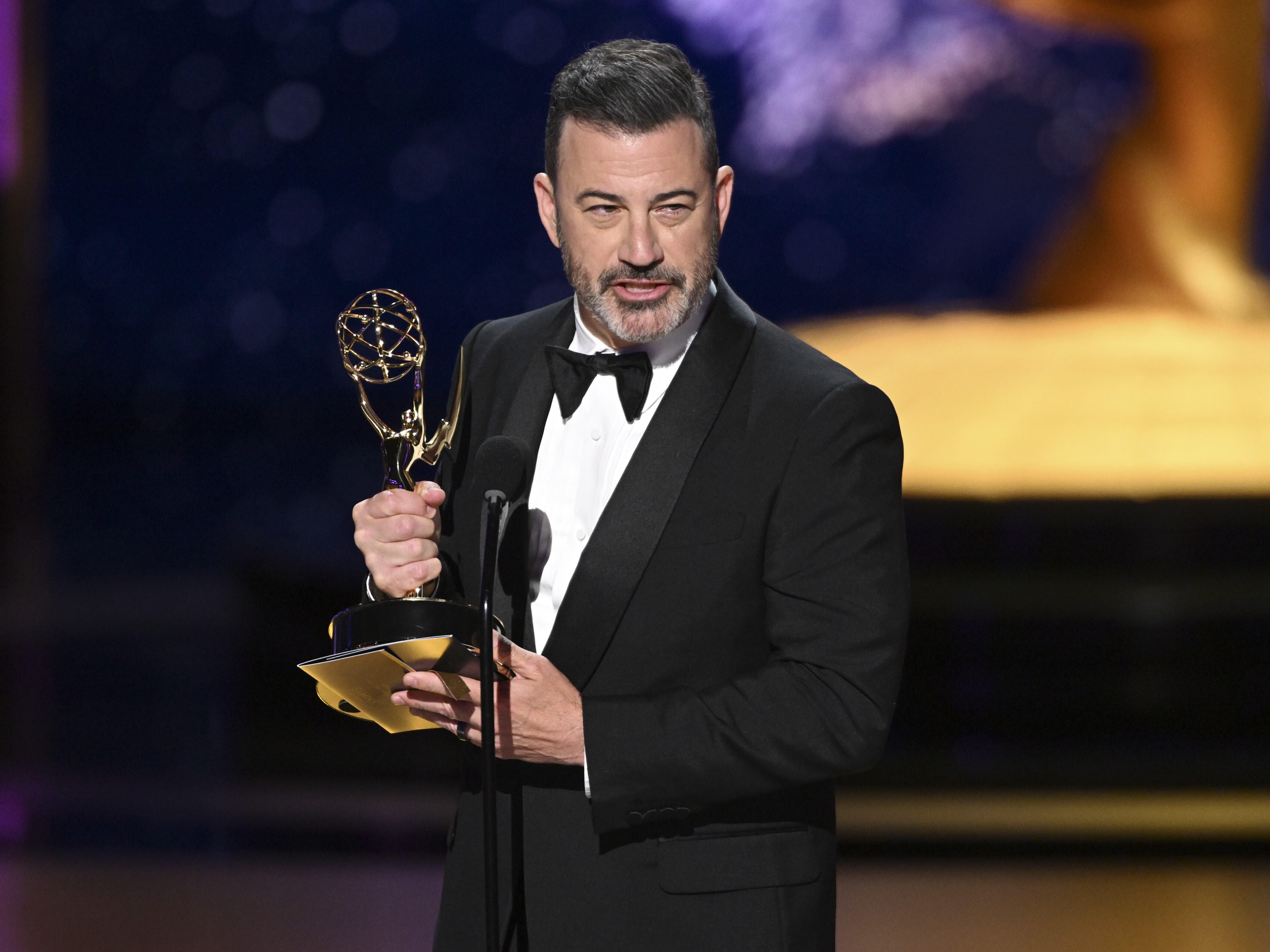 caption: Jimmy Kimmel accepts the Outstanding Host for a Game Show Emmy for <em>Who Wants To Be A Millionaire</em> during night two of the Television Academy's 2025 Creative Arts Emmy Awards on Sept. 7, 2025 at the Peacock Theater in Los Angeles.