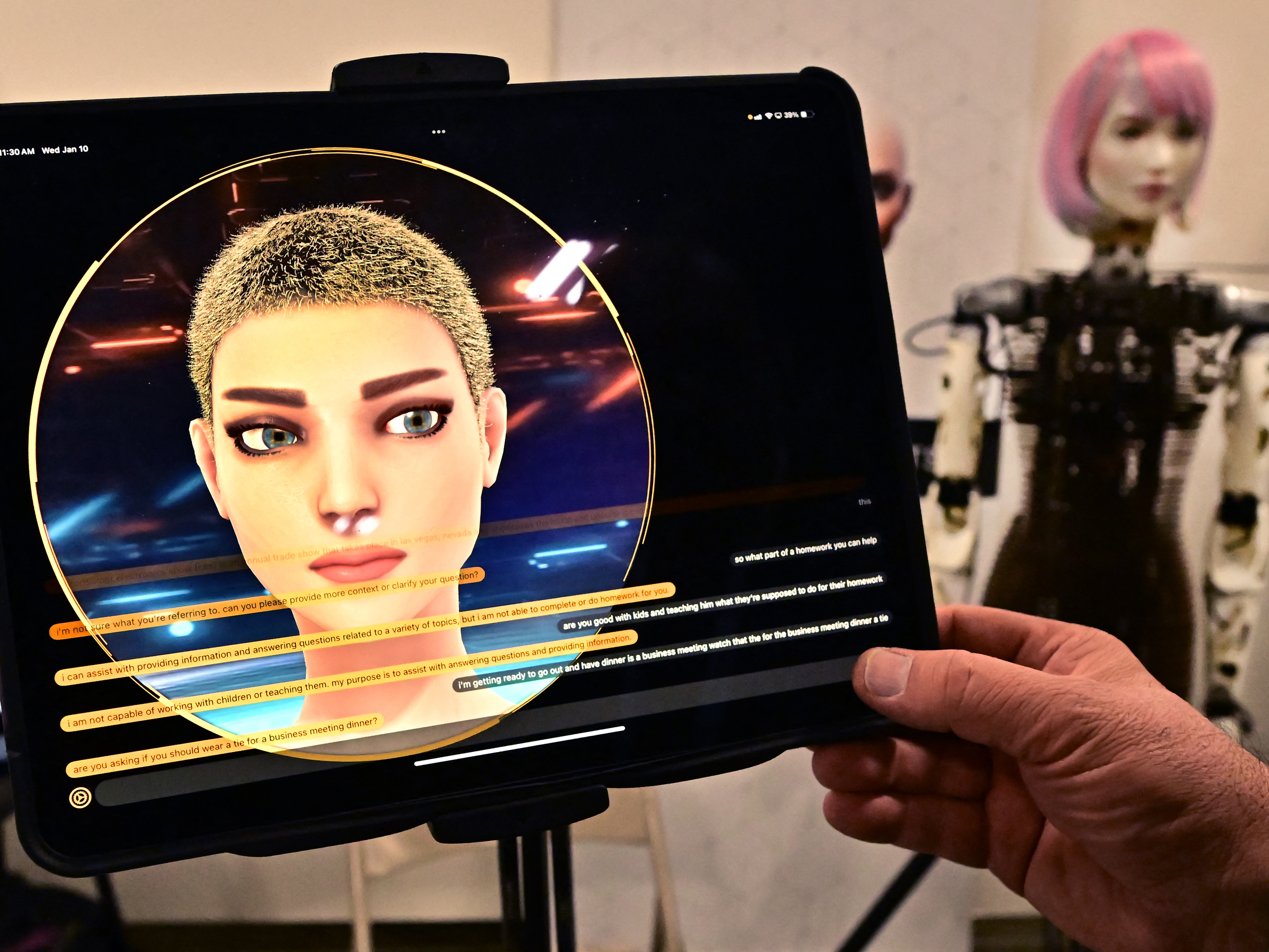 caption: A person has a conversation with a humanoid robot from AI Life, on display at the Consumer Electronics Show (CES) in Las Vegas.