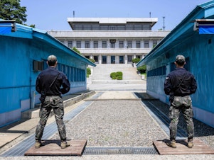 caption: In this photo taken on May 9, South Korean soldiers stand guard as they face North Korea in the Joint Security Area of the Demilitarized Zone separating North and South Korea.