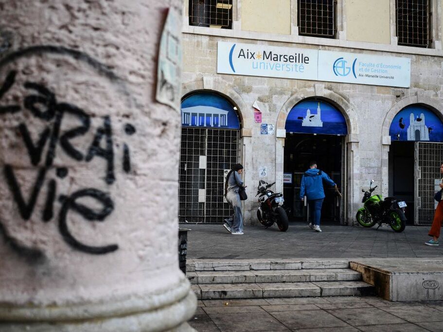 caption: People walk past the faculty of economy of the Aix-Marseille University in Marseille on Oct. 4, 2023.