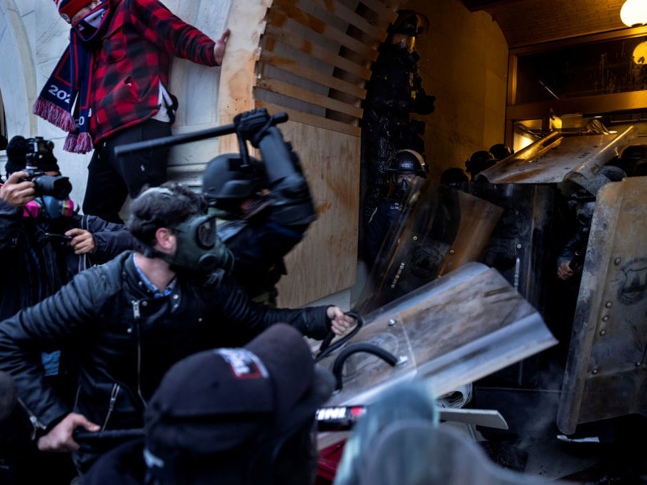 caption: Rioters clash with police and security forces as people try to storm the U.S. Capitol on Jan. 6. The FBI is undertaking an extensive investigation to identify and charge hundreds of individuals.