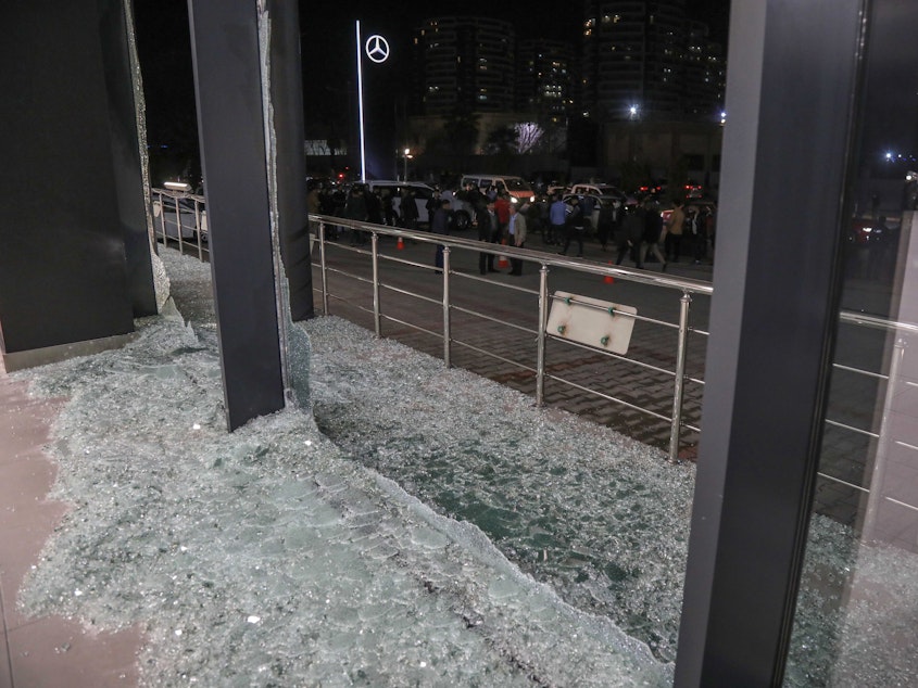 caption: Shattered glass is on the ground following a rocket attack in Irbil, the capital of the northern Iraqi Kurdish autonomous region, on Feb. 15. On Thursday, the U.S. launched airstrikes targeting Iranian-backed groups in eastern Syria in response to recent attacks against Americans in Iraq.