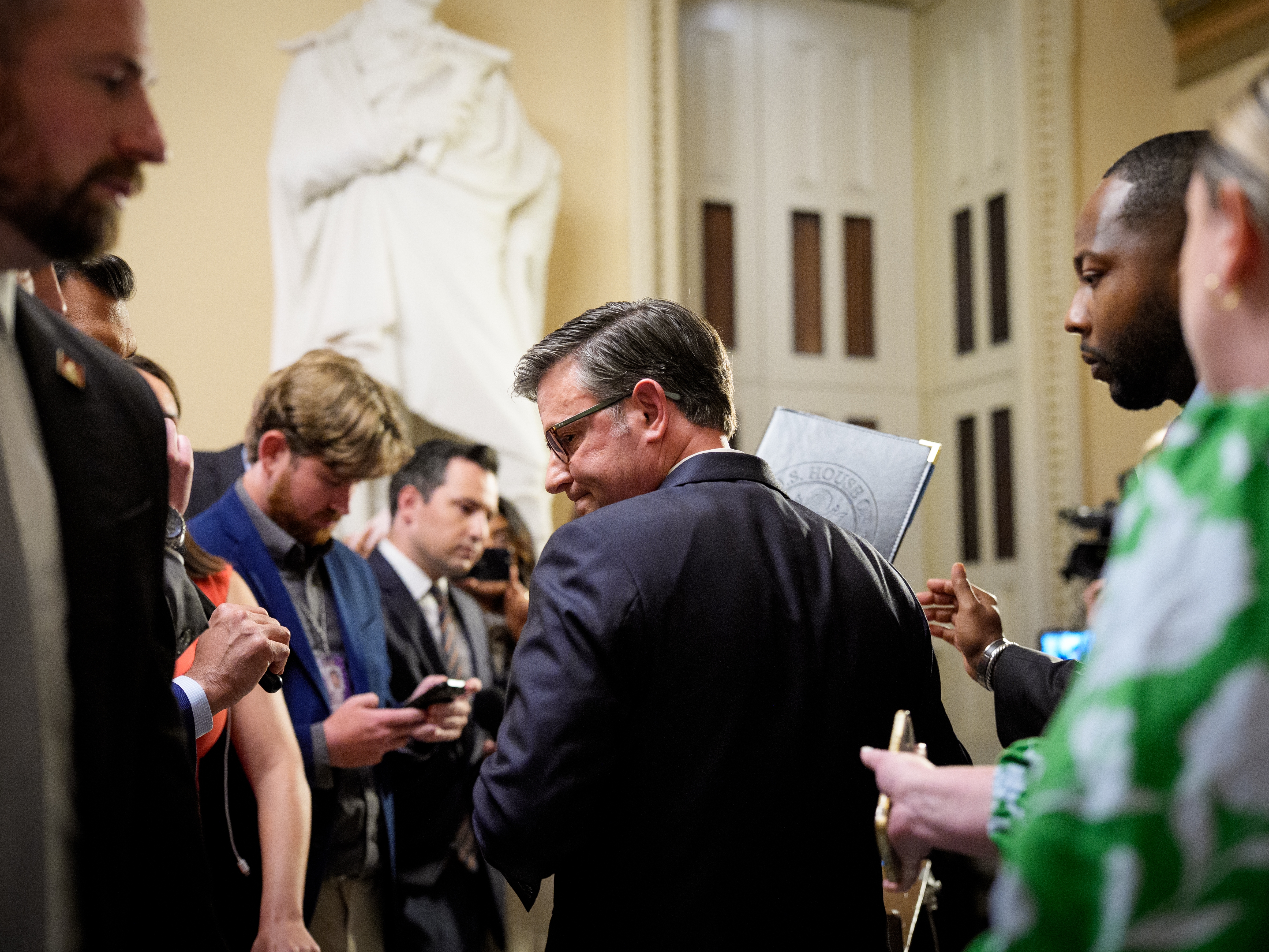 caption: House Speaker Mike Johnson departs after speaking to reporters outside the House chamber at the U.S. Capitol on July 23, 2025, in Washington, D.C.