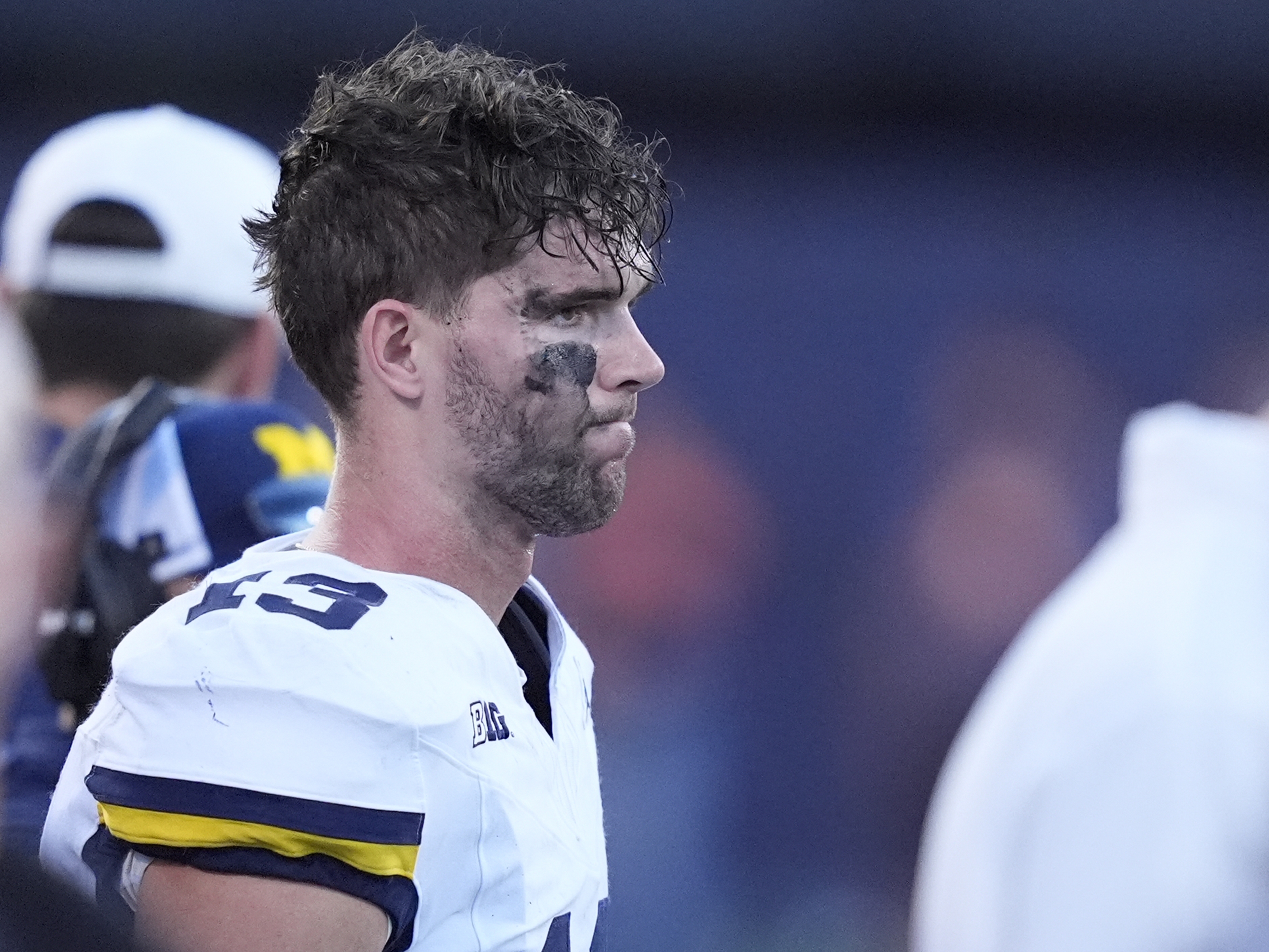 caption: Michigan quarterback Jack Tuttle stands on the sidelines in the closing minutes of the team's 21-7 loss to Illinois in an NCAA college football game Saturday, Oct. 19, 2024, in Champaign, Ill.
