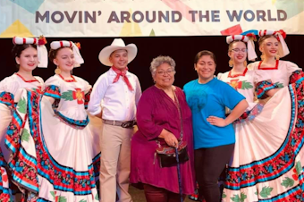 caption: Francisca Garcia (middle) and her daughter Luna Garcia (third from right) pose with dancers after a performance at a recent Northwest Folklife festival. Luna Garcia is the co-director of Joyas Mestizas, a non-profit youth folkloric dance group that preserves the rich cultural heritage and diversity of Mexico.
