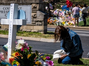caption: A woman prays at a makeshift memorial for those killed in a mass shooting at the entrance of The Covenant School on March 29, 2023 in Nashville, Tennessee. Three students and three adults were killed by the 28-year-old shooter on Monday.