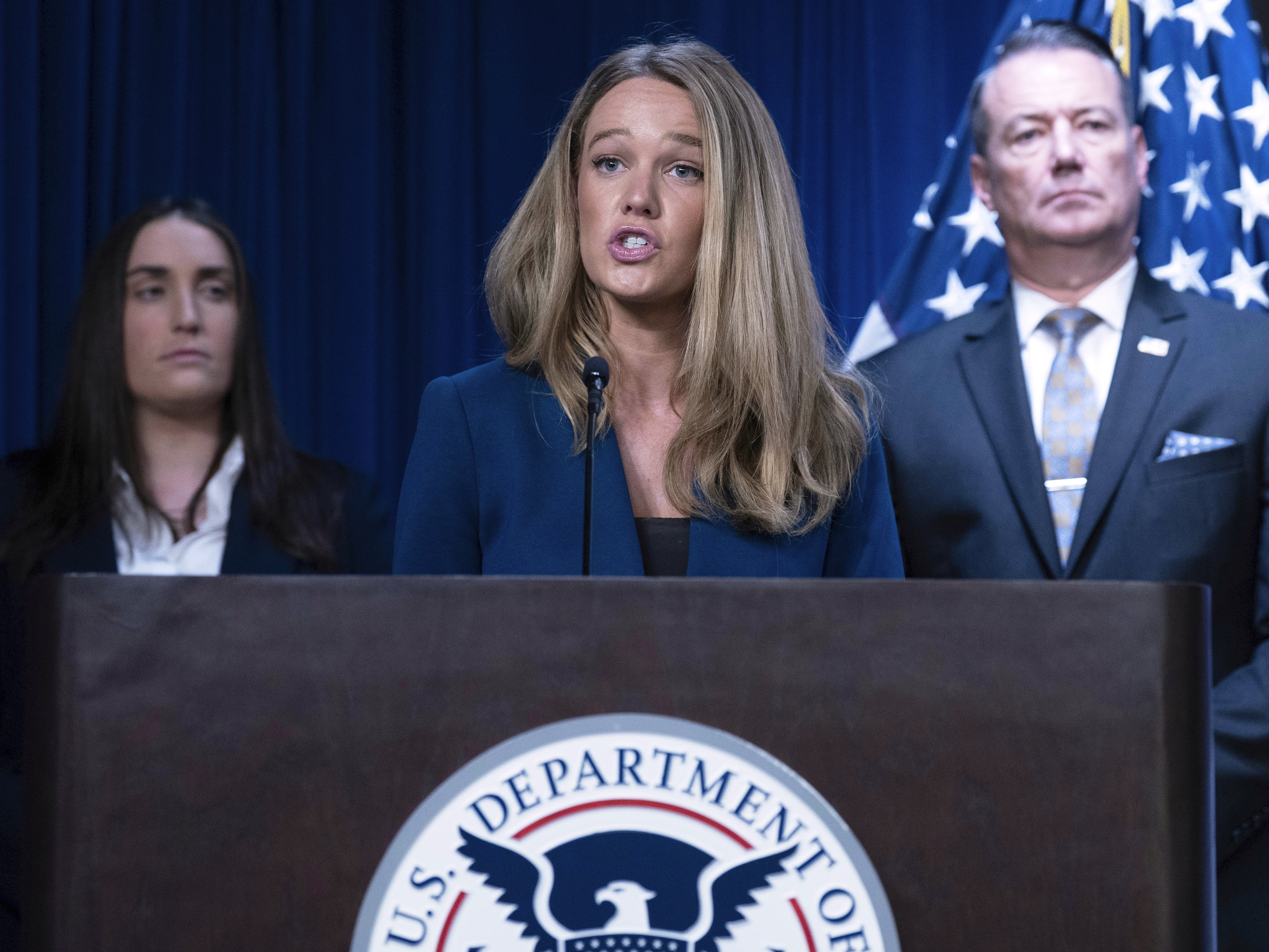 caption: DHS Assistant Secretary for Public Affairs Tricia McLaughlin speaks during a news conference at ICE Headquarters, in May 2025.
