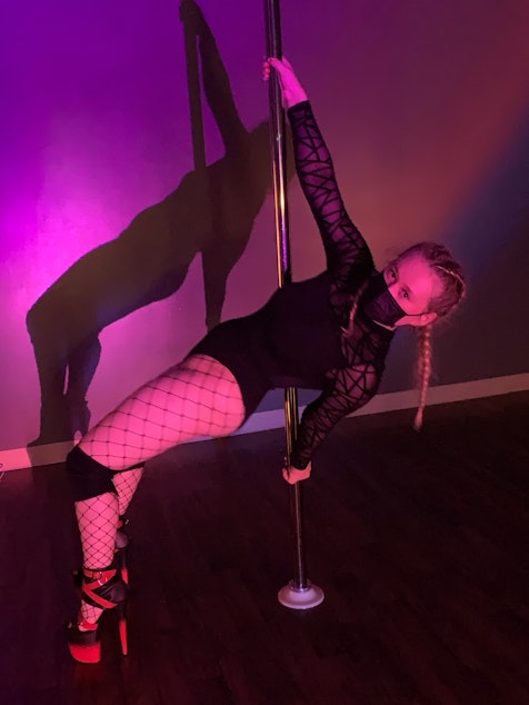 caption: Morgen White poses after her final basic heels class at Divine Movement Pole Dance & Fitness in Seattle in May 2022. "A triumph," White says.
