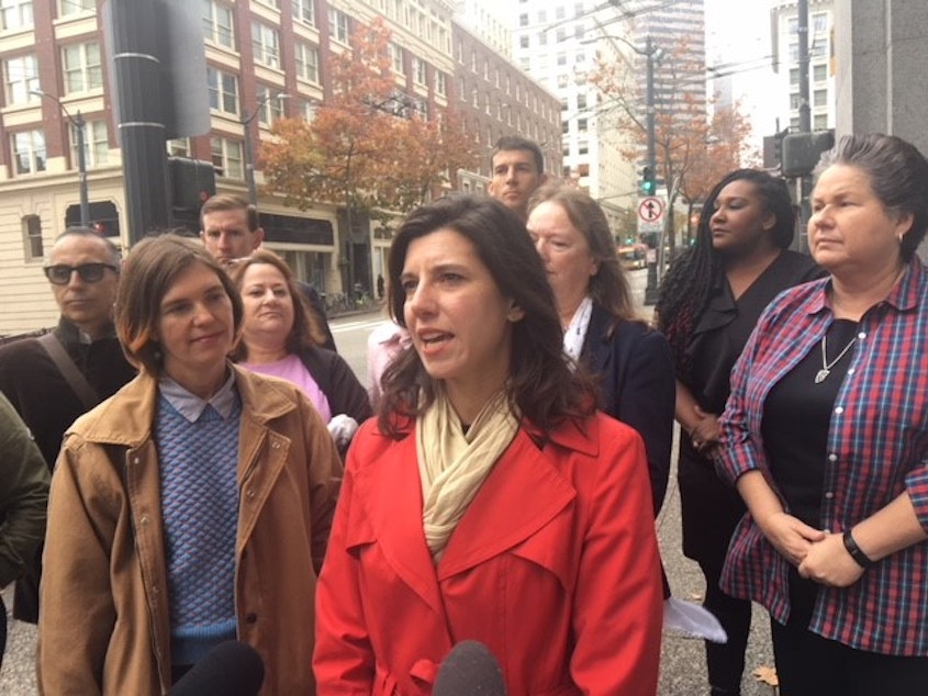 caption: King County Labor Council executive secretary-treasurer Nicole Grant (left), former state Rep. Jessyn Farrell (center) and Washington State Democrats chair Tina Podlodowski (right), among others, called for Sen. Joe Fain's resignation on Tuesday.