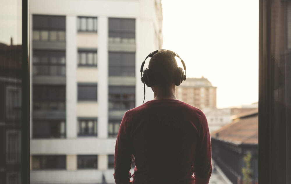 caption: A man wears headphones. (Getty Images)
