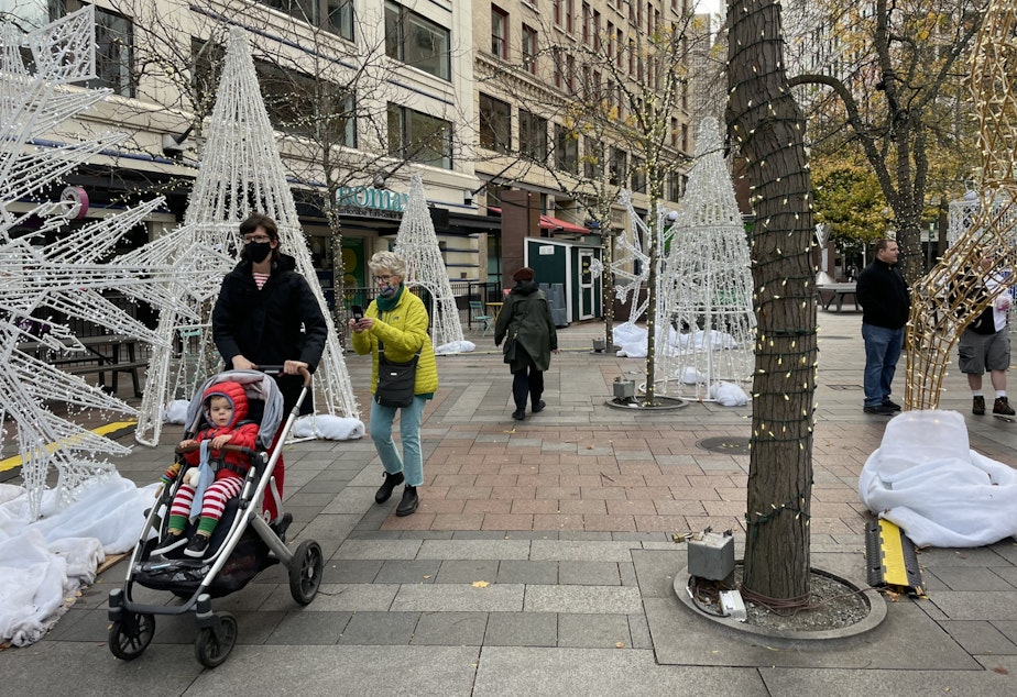 caption: Even in the daytime, holiday lighting displays draw visitors to downtown Seattle