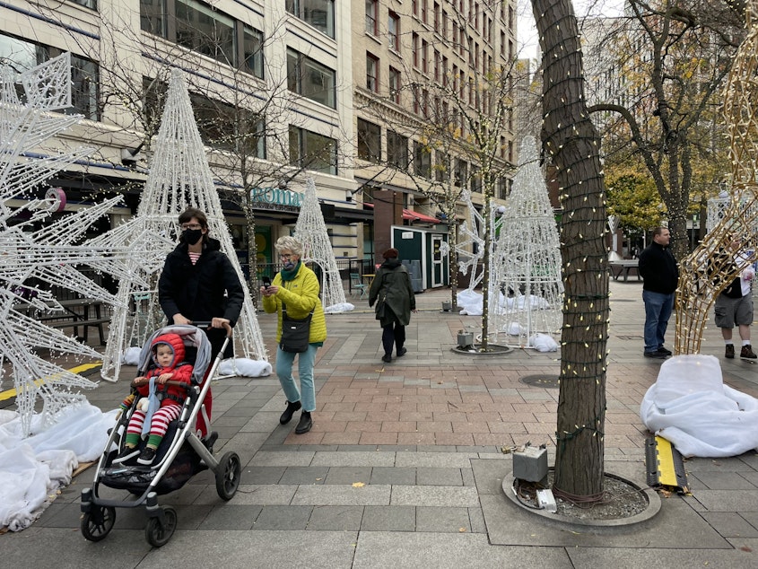 caption: Even in the daytime, holiday lighting displays draw visitors to downtown Seattle