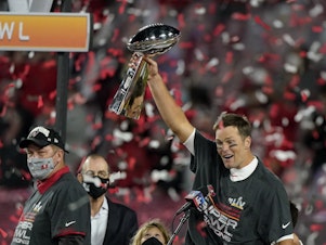 caption: Quarterback Tom Brady celebrates with the Vince Lombardi Trophy after leading theTampa Bay Buccaneers to Super Bowl victory against the Kansas City Chiefs on Sunday.