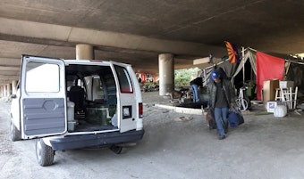 caption: Darrel Sutton, after camping in Seattle's Jungle homeless camp for more than a year, moves with help from Union Gospel Mission workers in October 2016.