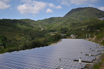 caption: Japan plans to ramp up its use of solar panels, such as these shown in Yufu, Oita prefecture in 2019.