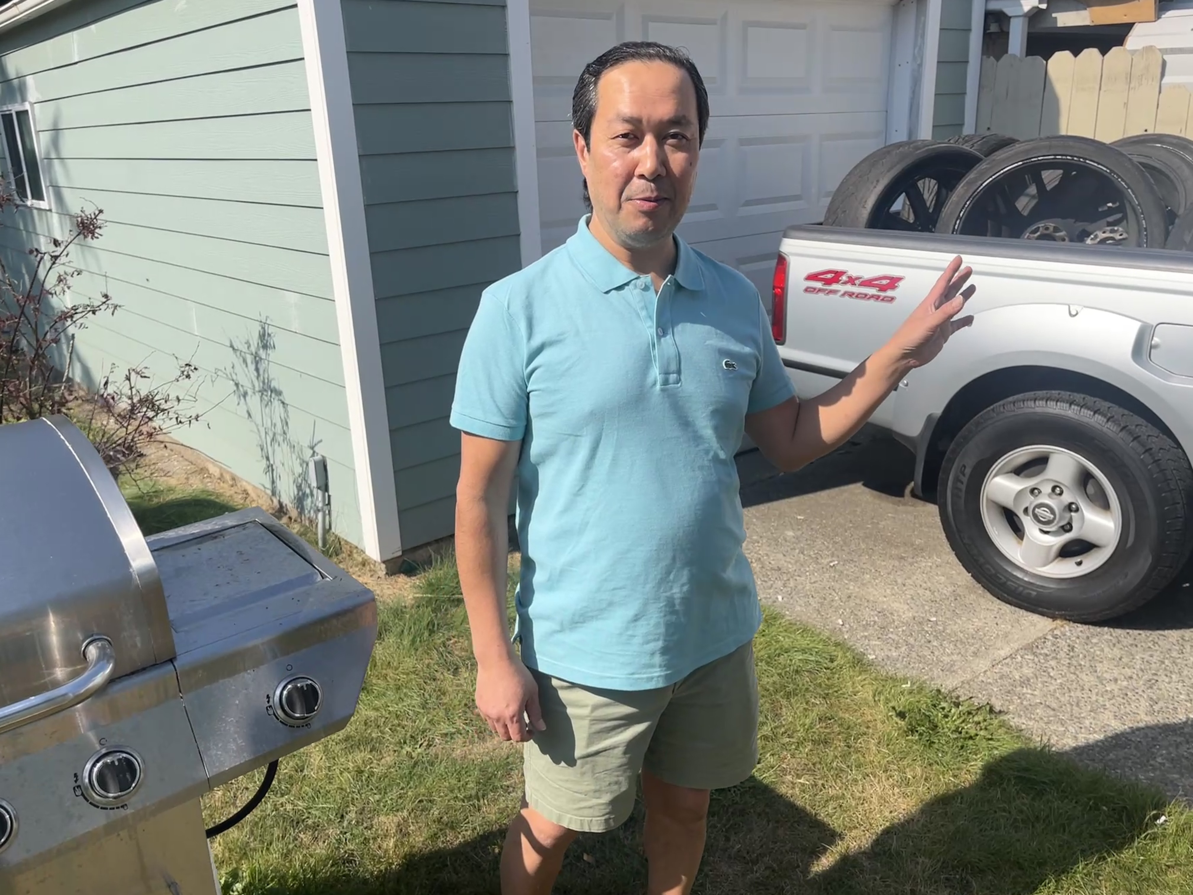 caption: Standing in his backyard on Sept. 23, 2025, Alan Phetsadakone explains his family's ties in the neighborhood and how he fixed up his truck. 