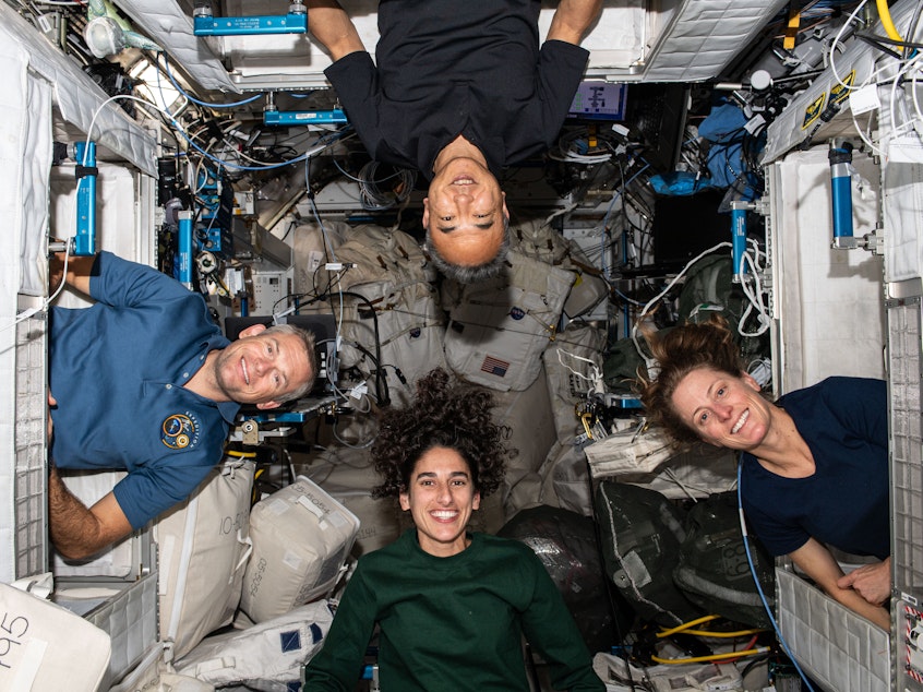 caption: The four members of NASA's Crew-7 mission pose for a portrait inside their crew quarters on the International Space Station. Clockwise from bottom are, astronauts Jasmin Moghbeli, Andreas Mogensen, Satoshi Furukawa, and Loral O'Hara. The SpaceX Crew Dragon capsule splashed down at 5:48 a.m. ET on Tuesday, March 12, 2024 to end a six-month mission.