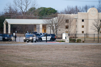caption: Police stand in front of the Congregation Beth Israel synagogue, Sunday, Jan. 16, 2022, in Colleyville, Texas. A man held hostages for more than 10 hours Saturday inside the temple. The hostages were able to escape and the hostage taker was killed. FBI Special Agent in Charge Matt DeSarno said a team would investigate "the shooting incident." 