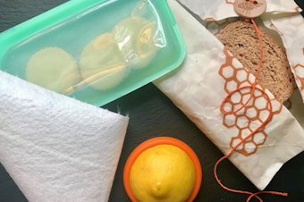 caption: Last year, the author set about reducing her reliance on single-use disposables in the kitchen. Above are some of the tools she has adopted for food storage: a heavy-duty reusable silicone zip-top bag, bamboo towels, silicone disks that slip over the ends of cut pieces of fruits and vegetables, and beeswax-covered fabrics.