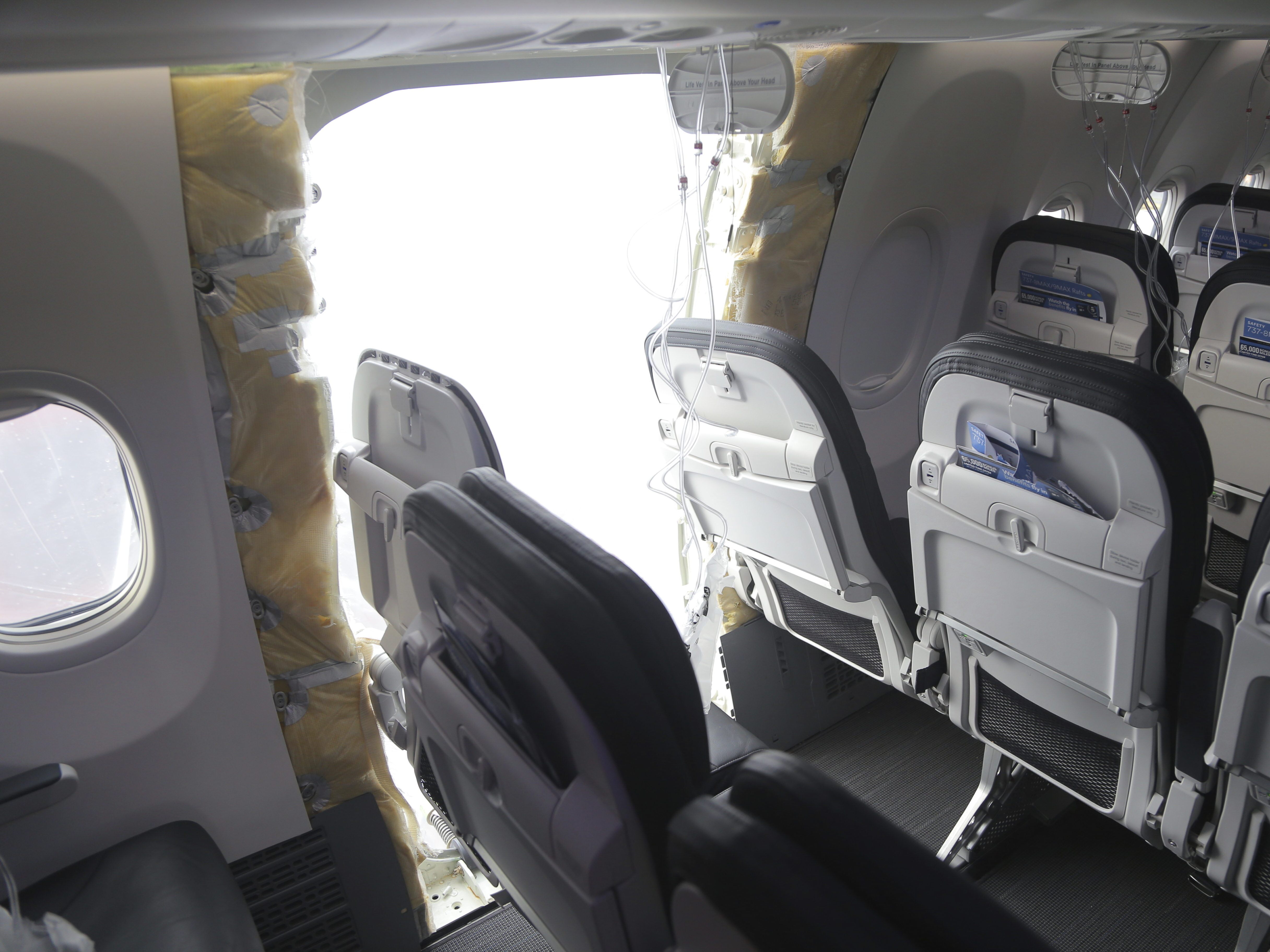 caption: This image shows the section of a Boeing 737 Max where a door plug blew out while Alaska Airlines Flight 1282 was at 16,000 feet in January. 