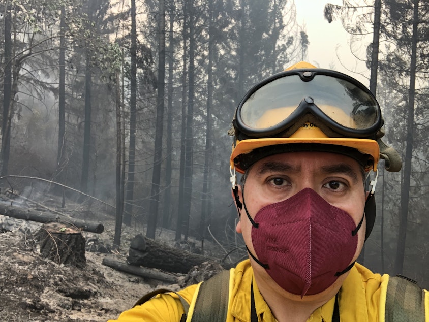 caption: KLCC reporter Brian Bull poses in full fire-safety gear at Division LL (Lima Lima) of the Middle Fork Complex in August 2021.