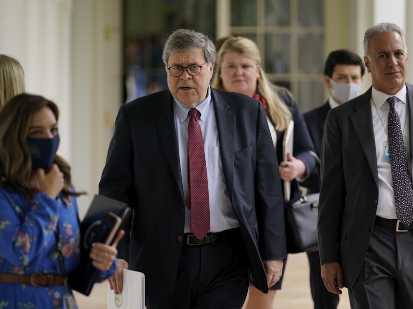 caption: Attorney General William Barr, center, arrives for an event on police reform last month at the White House. Barr is expected to face tough questioning when he appears Tuesday before the House Judiciary Committee.