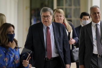 caption: Attorney General William Barr, center, arrives for an event on police reform last month at the White House. Barr is expected to face tough questioning when he appears Tuesday before the House Judiciary Committee.