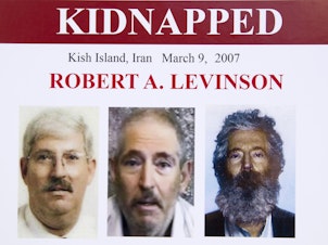 caption: An FBI poster from 2012 shows (from left) former FBI agent Robert Levinson before his capture, in a video released by his kidnappers and as a composite image of what he might look like after five years in captivity.
