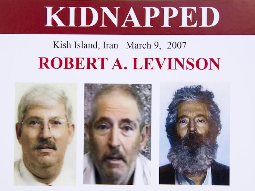 caption: An FBI poster from 2012 shows (from left) former FBI agent Robert Levinson before his capture, in a video released by his kidnappers and as a composite image of what he might look like after five years in captivity.
