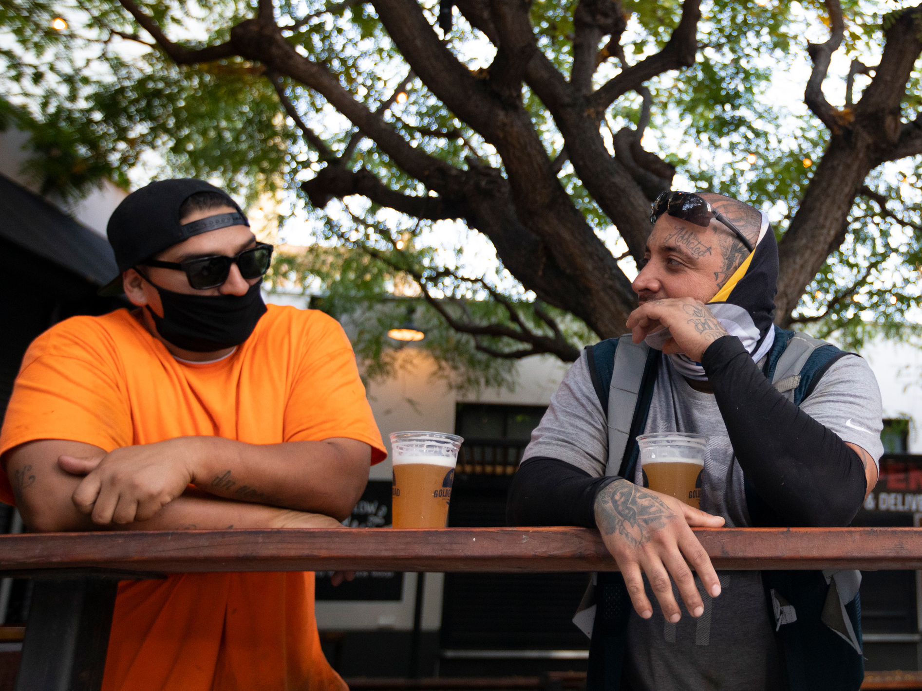caption: With new coronavirus infections climbing in most states, infectious disease experts are discouraging group get-togethers, especially those that involve drinking. In this photo patrons enjoy a beer outside the Central Market in Los Angeles, this week.