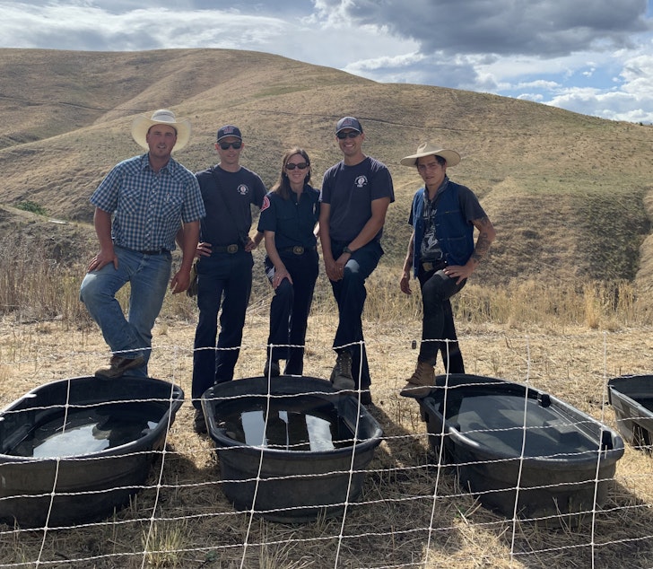 caption: Goat owner Billy Porter, community wildlife specialists Jon Riley and Hillary Heard, Armondo Farias and herder Todd Waits.